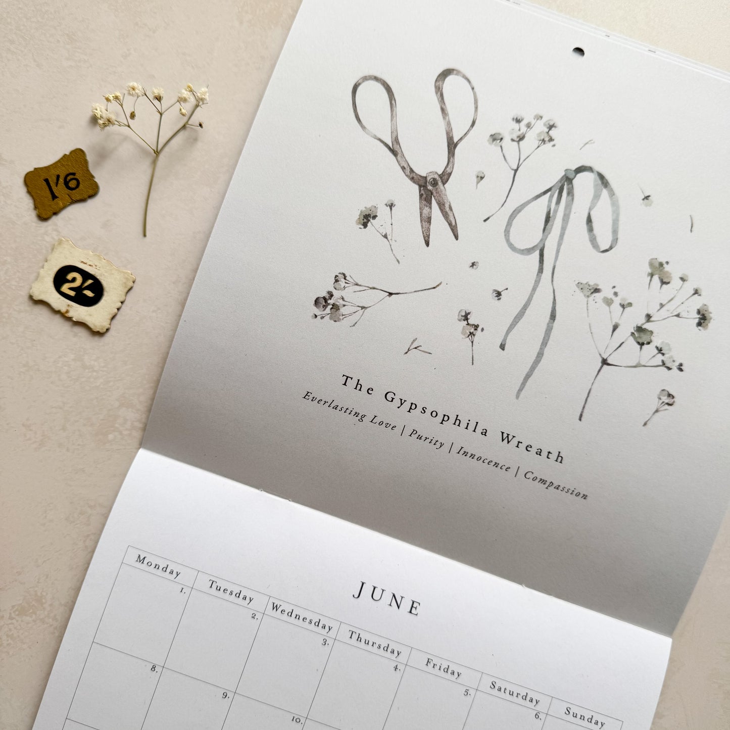 Calendar with botanical design and decorative elements on a beige background